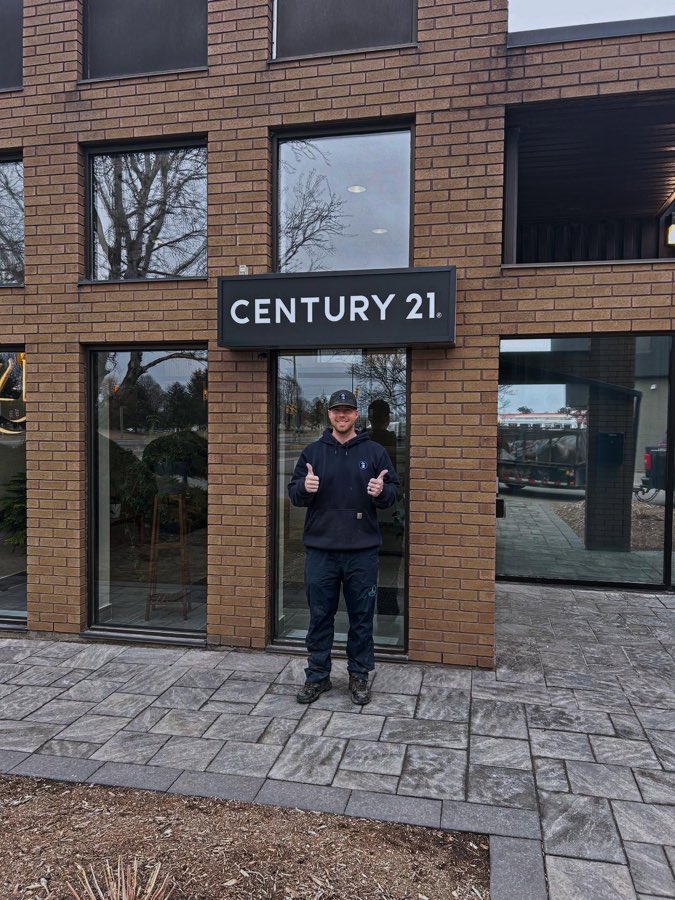 Brock outside the Century 21 real estate office