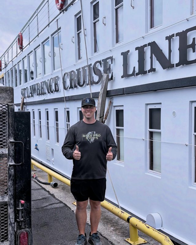 Brock giving a thumbs up on the dock in front of a St. Lawrence Cruise Lines vessel