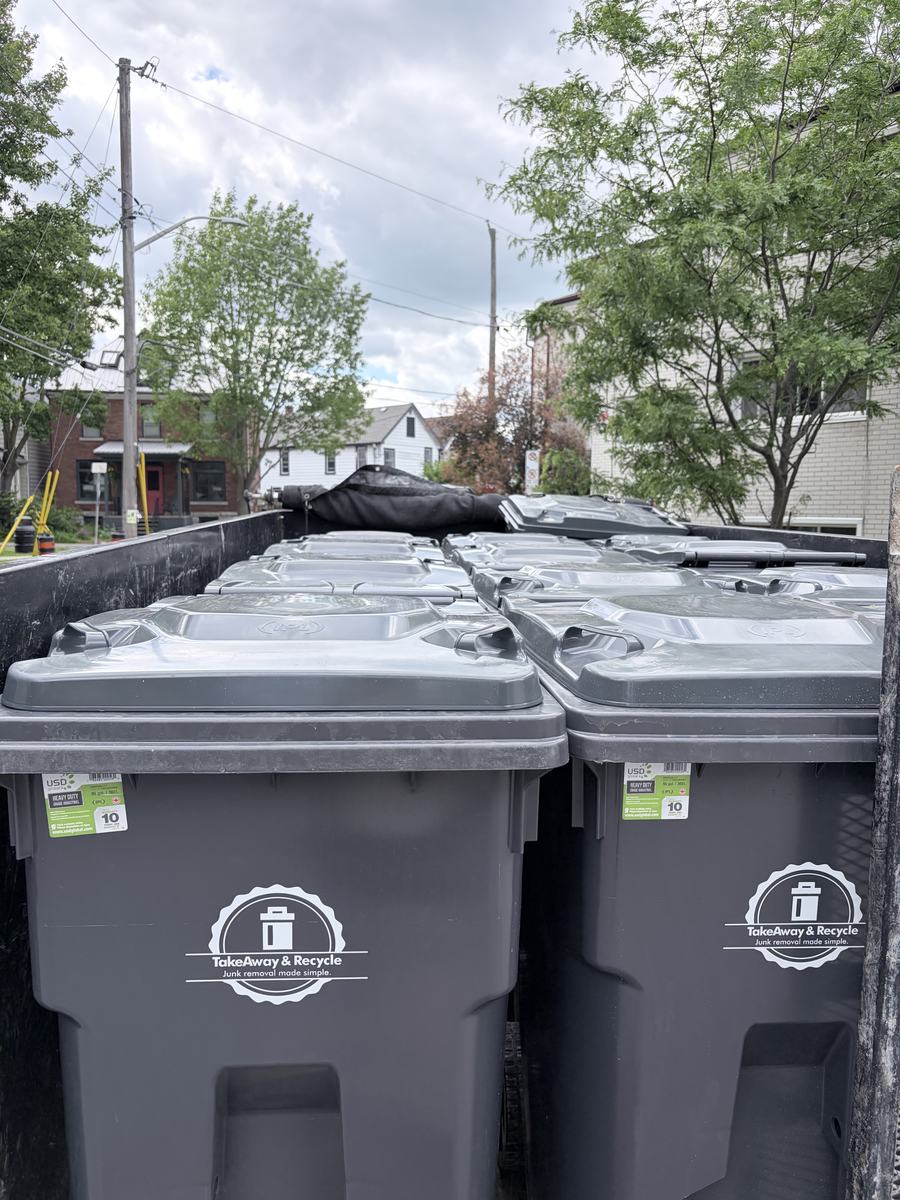 A trailer full of branded TakeAway & Recycle bins on a Kingston side street, ready to be dropped off
